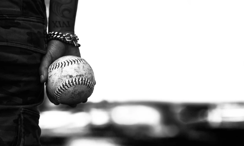 an image of a person that has his arm wrapped around a baseball