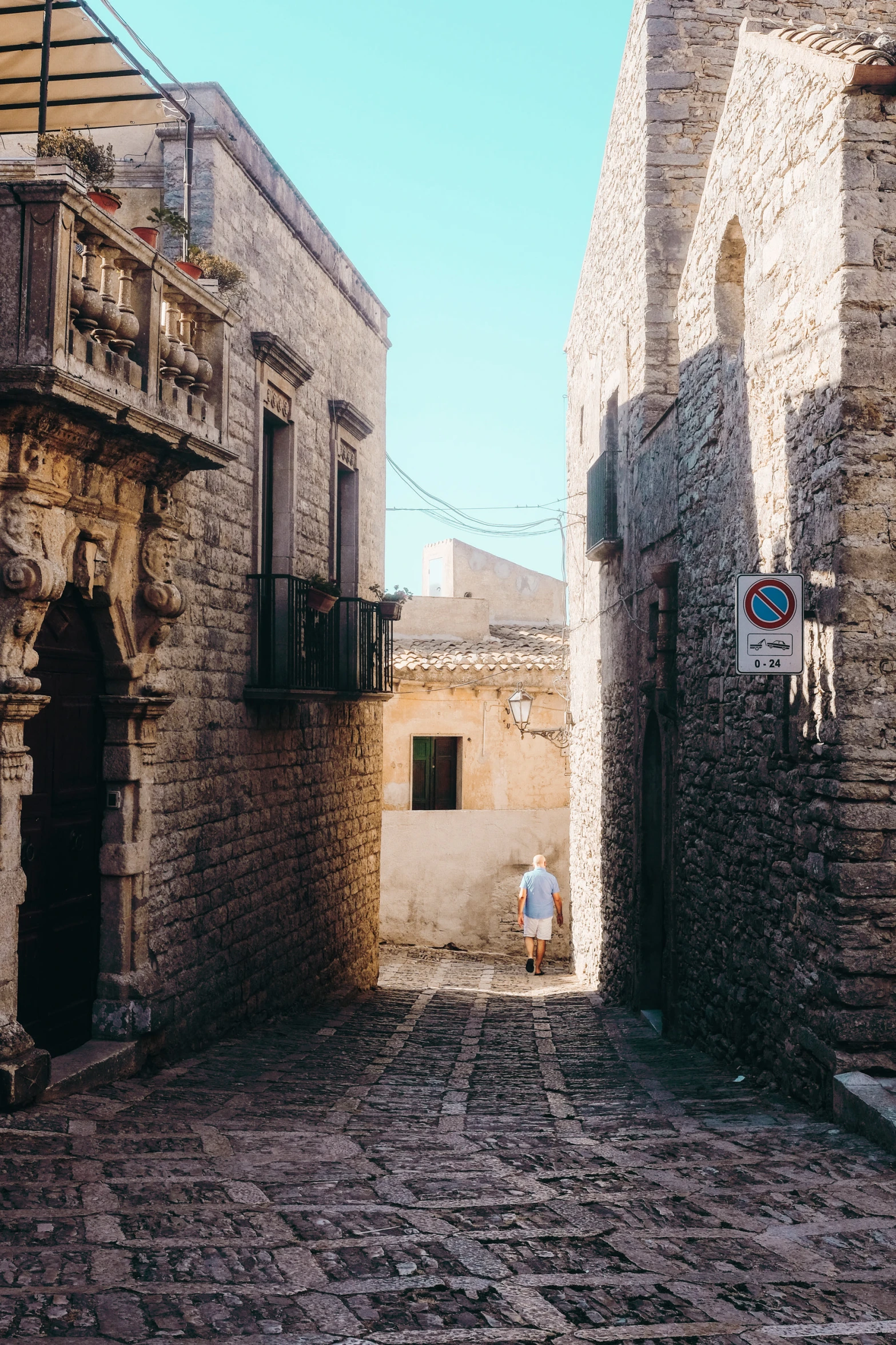 two men are standing outside of some small buildings