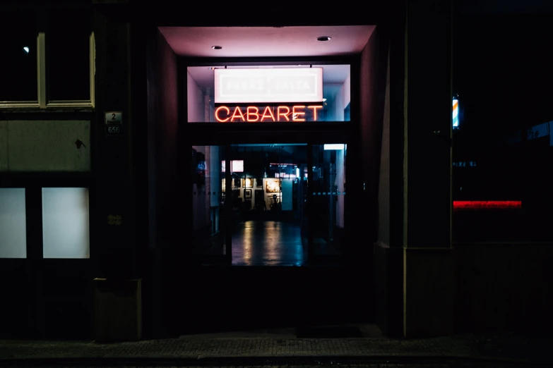 the entrance to the el's neon sign glows in the dark