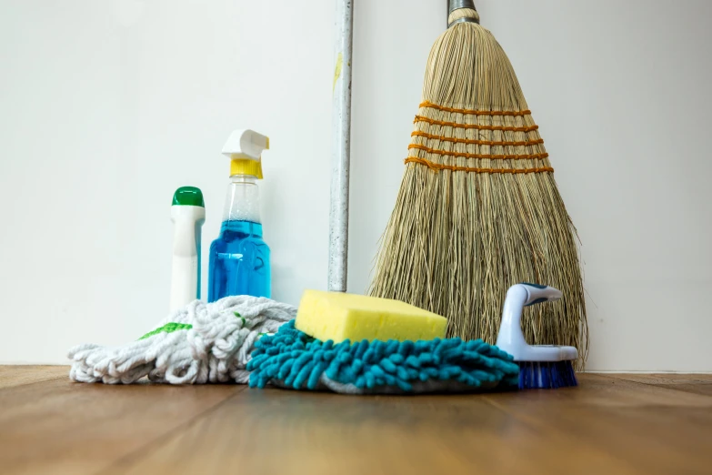 a wooden floor with cleaning equipment next to it