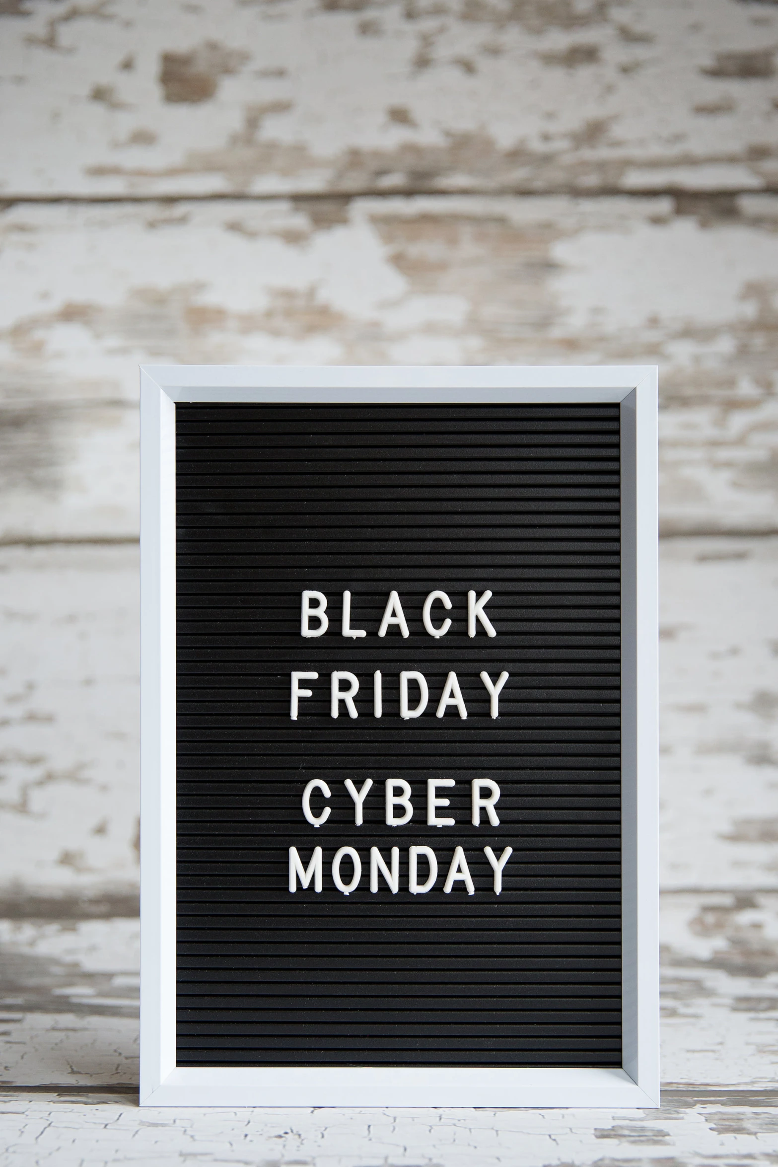 an old board has been painted black friday cyber monday