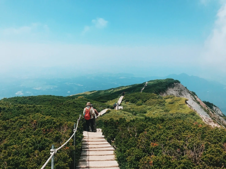 a person on a staircase leading down to the top of a mountain