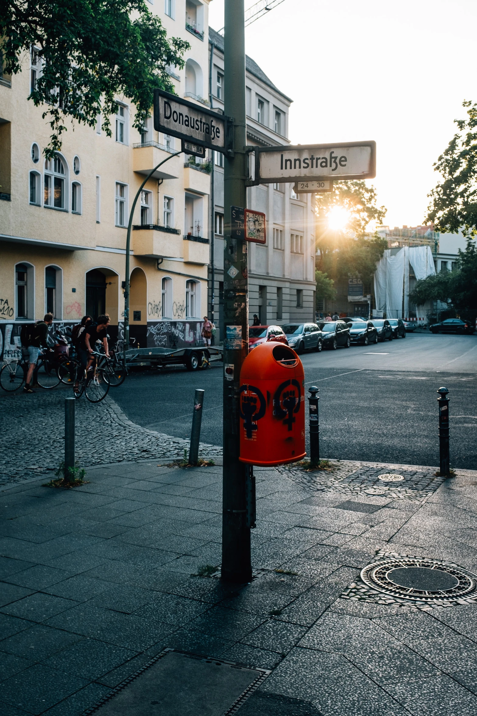 a red mailbox is in front of an apartment building