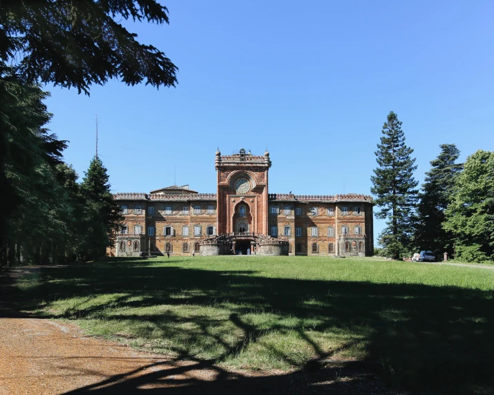 large building sitting on top of a lush green field