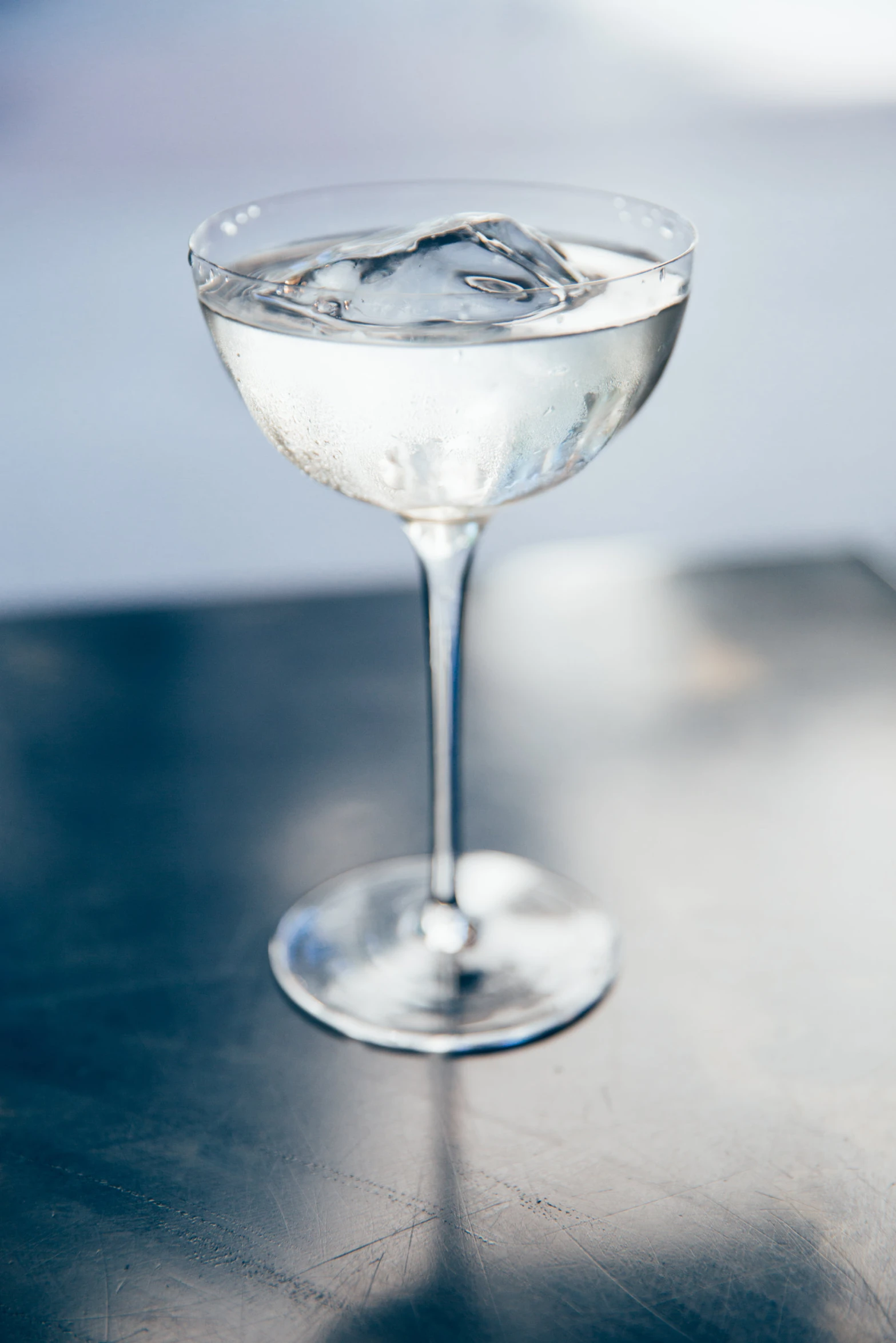 a glass with ice on a table