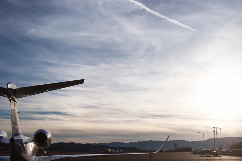 the plane is parked at an airport, the sky looks very bright