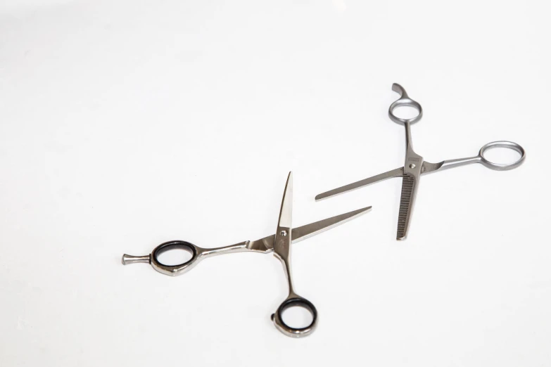 a pair of scissors with one open and the other closed