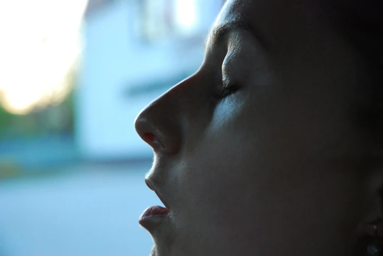 a woman with a nose ring looking upwards