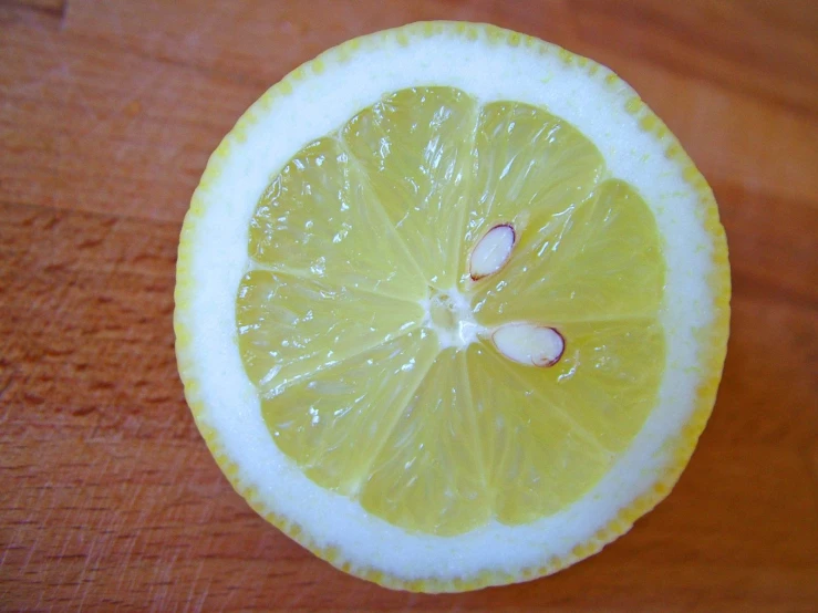 the slice of a lemon is lying on the surface