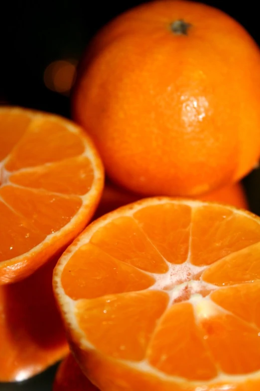 three oranges with the whole fruit still attached