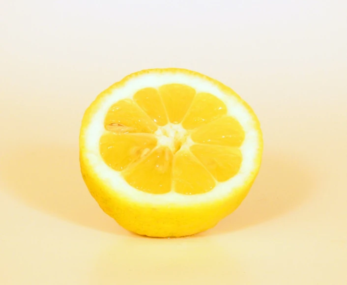 a half of an orange is seen on a light surface