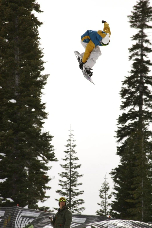 the snowboarder is performing an aerial trick