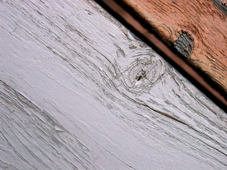 a weathered wood plank sits on the wall