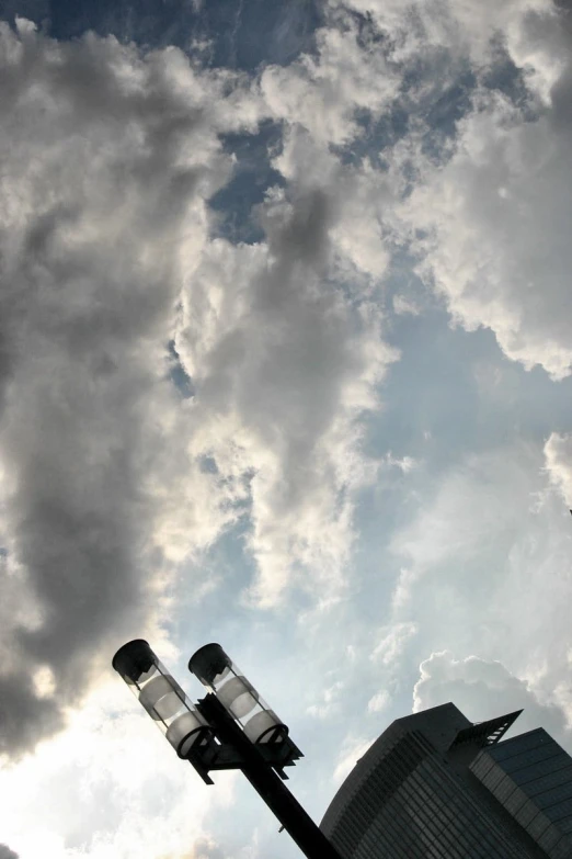 the sky is covered by some clouds over buildings