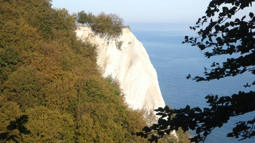 a scenic view of a cliff overlooking a body of water