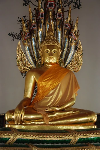 a golden statue wearing yellow with an orange dress