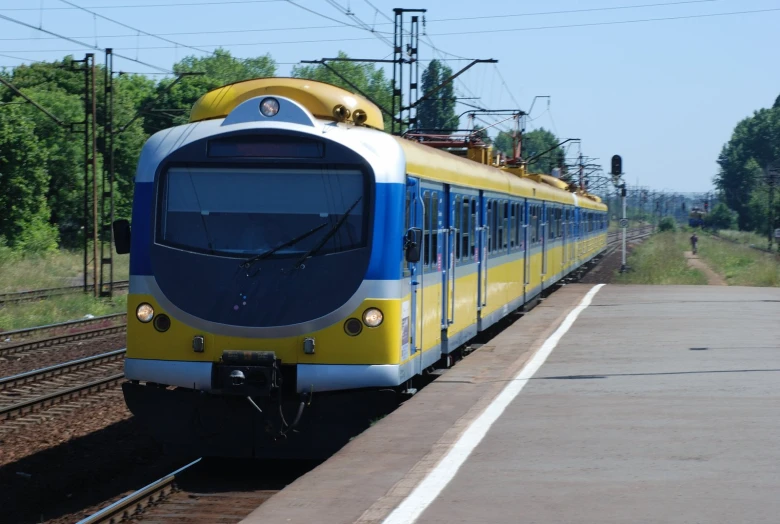 a yellow and blue train on train tracks