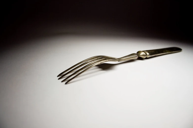 an odd object consisting of a fork and two balls