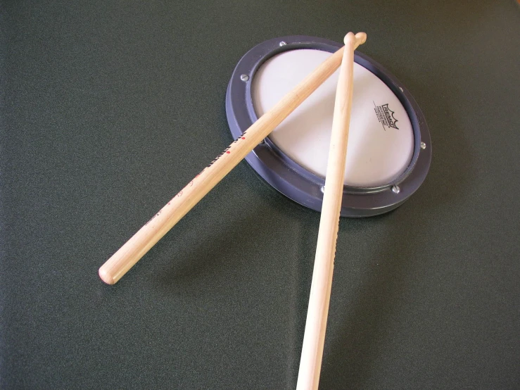 a couple of drumstick's on top of a drum kit