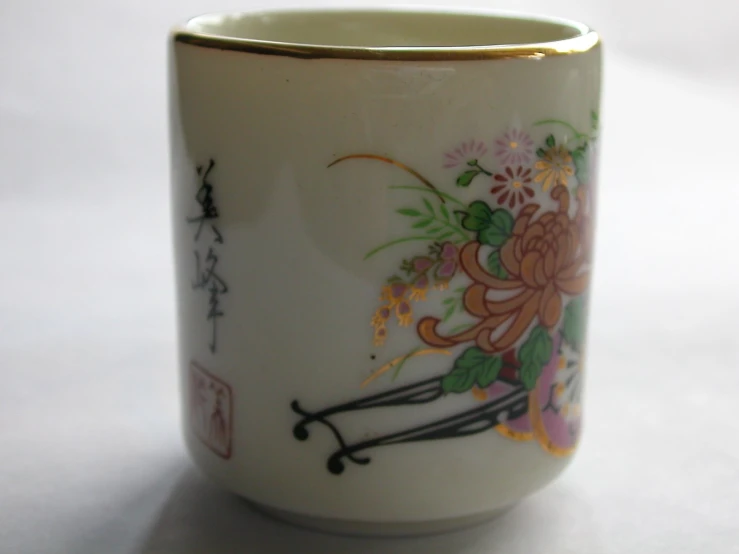 the white cup has floral designs on it