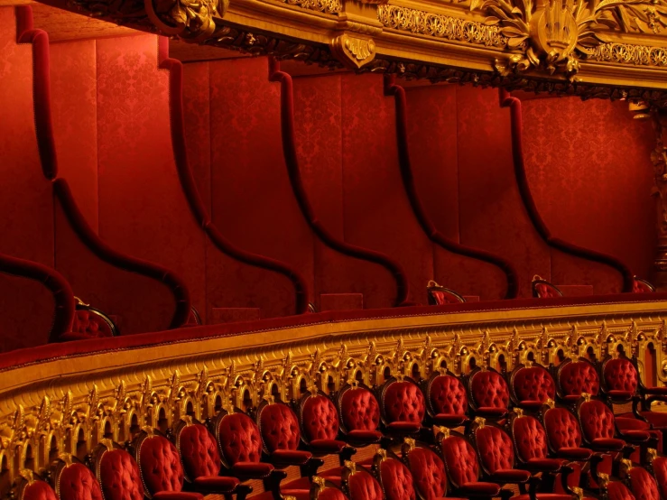 a large auditorium with red velvet chairs