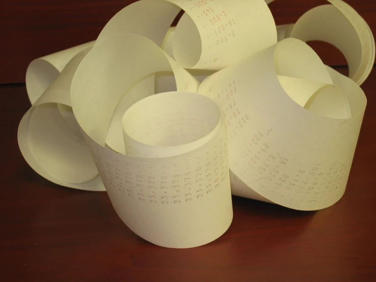 several toilet paper rolls stacked up on a table