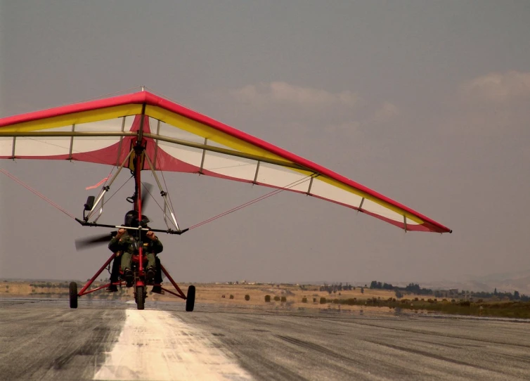 the man is gliding his glider over the ground