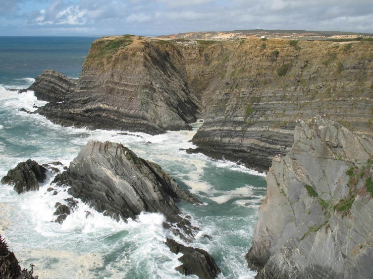 a beach with many rocks and a body of water