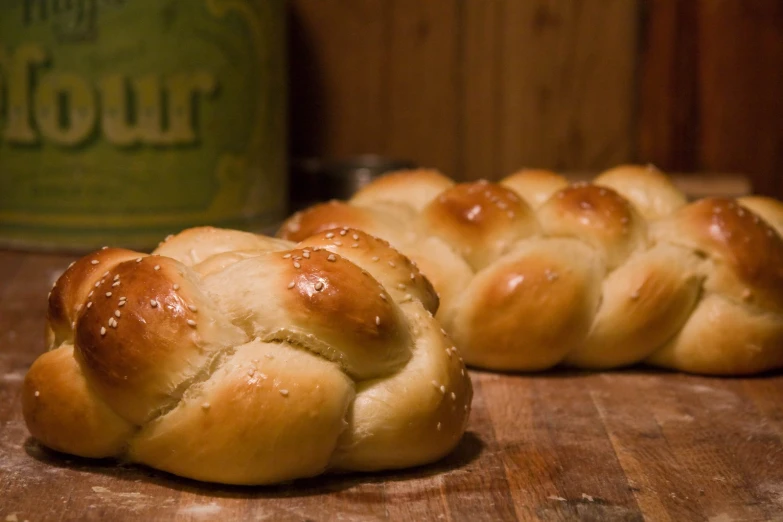 two bread buns sitting on top of a  board