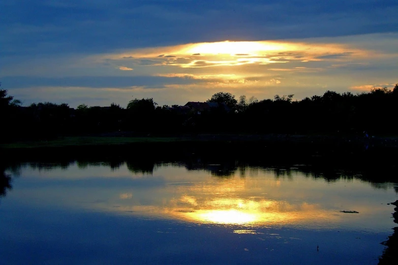 the sun is shining in the middle of the lake