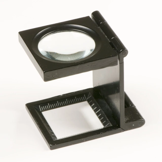 a magnifying glass sitting on top of a metal stand