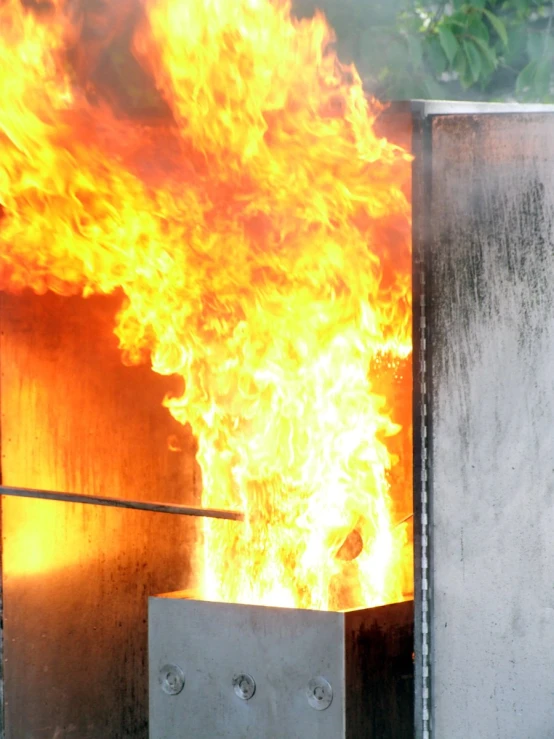 fire burning from an outdoor fireplace, during the day