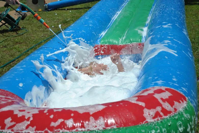 there is a man that is in the water slide