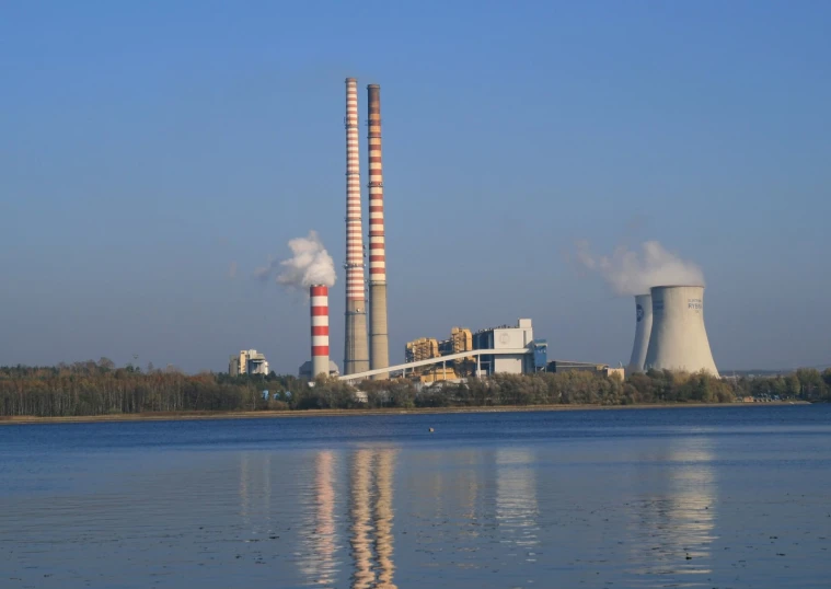 a couple of towers stand in front of a large body of water