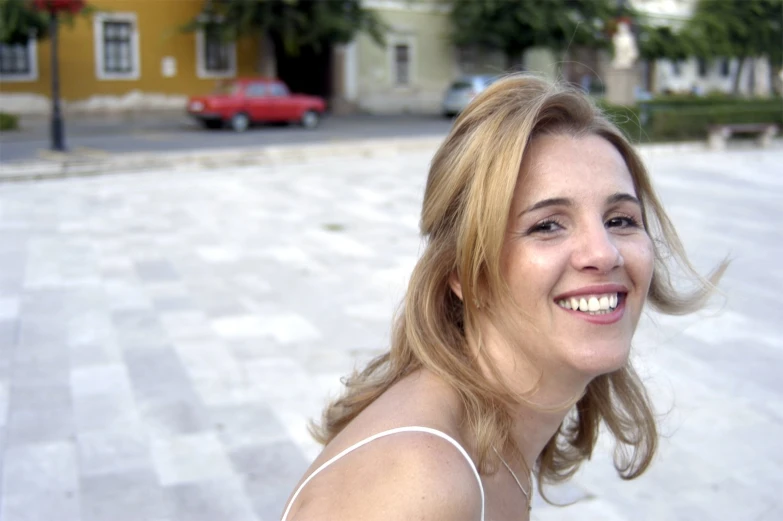 a woman is smiling and looking back at the camera