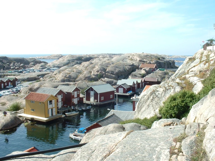 small boats sit at a pier next to some rocks