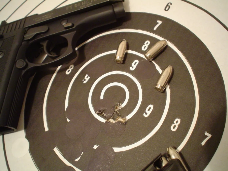 a gun and bullet on a target with two ss taken out