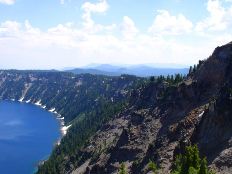 a view from top of a cliff over a lake