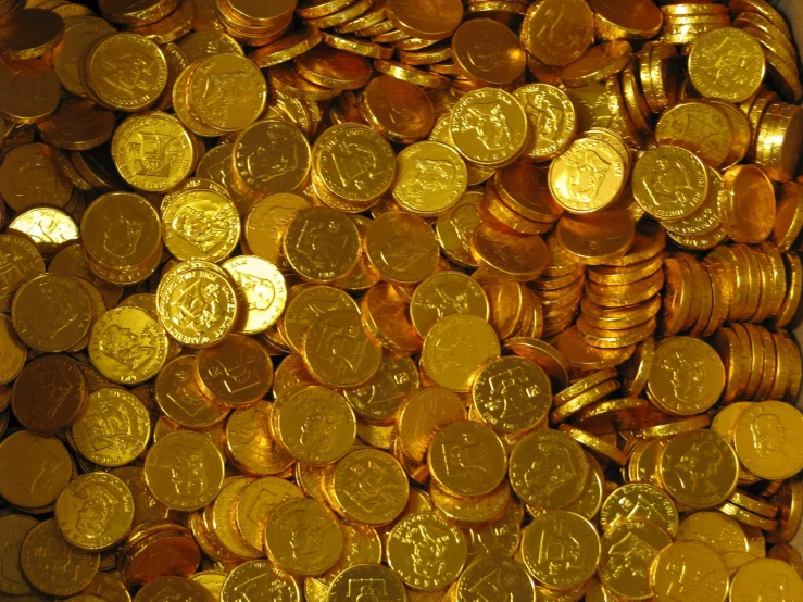 a pile of golden coins on top of each other
