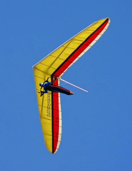 the bright yellow wing of an airplane in flight