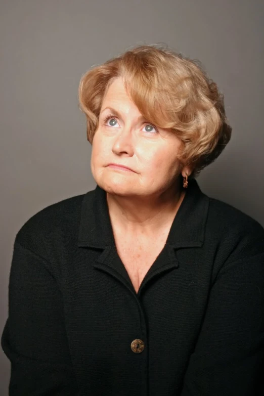 an older woman with blue eyes posing for a po