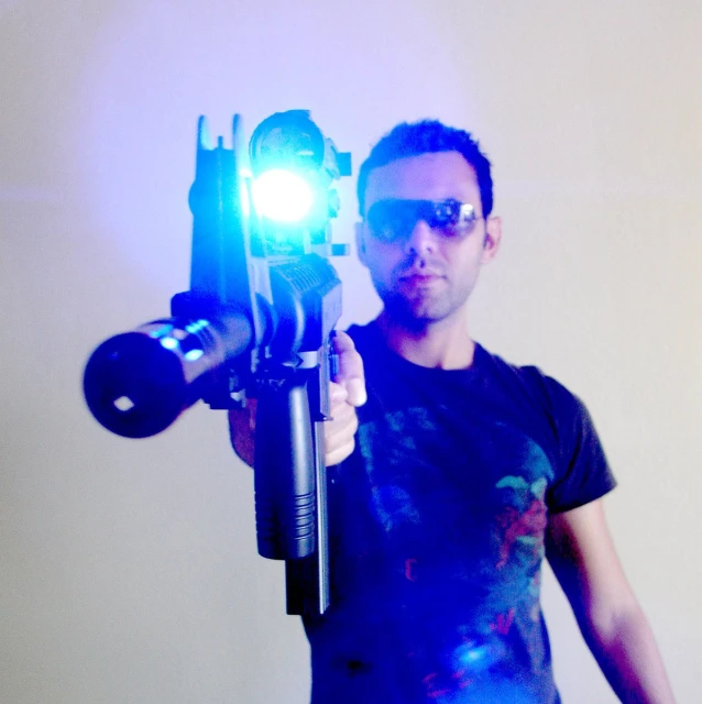 a man holding a camera up to the light