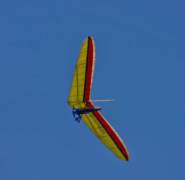 a large glider in the air against a clear sky