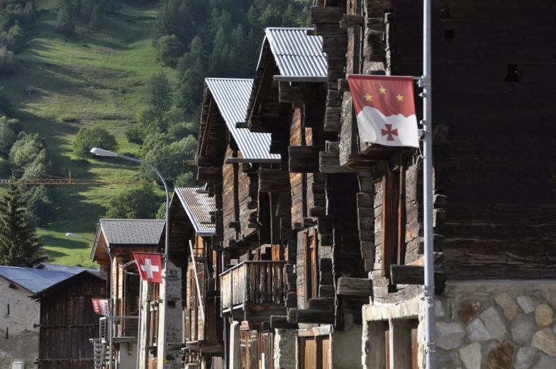 a row of buildings with mountains in the background