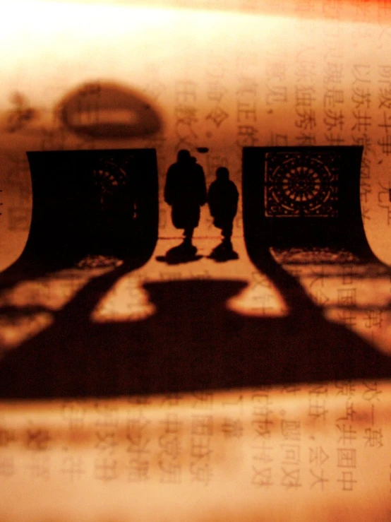 the shadow of two people standing in front of a clock tower