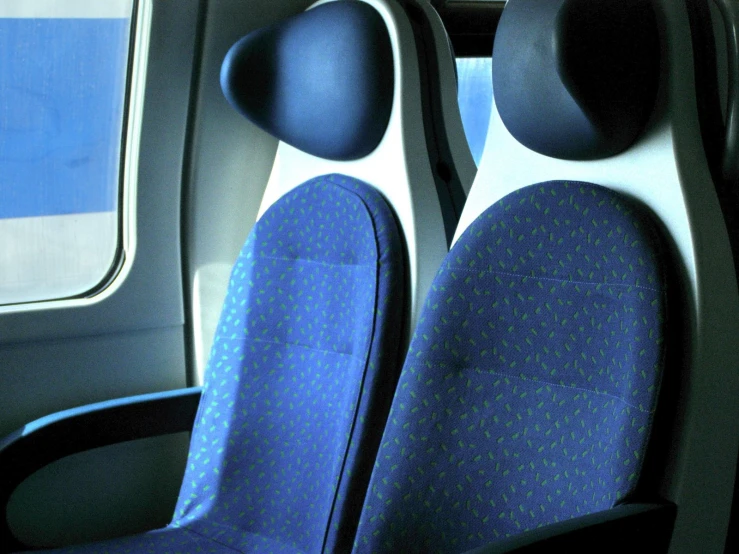 blue chairs in a seat with armrests and the window