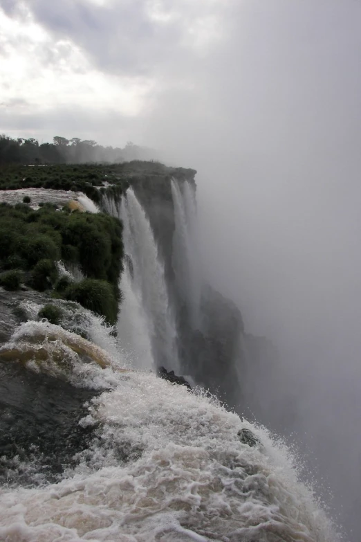 water splashing from a large waterfall into the air