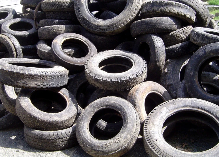 a pile of old tires are on the ground