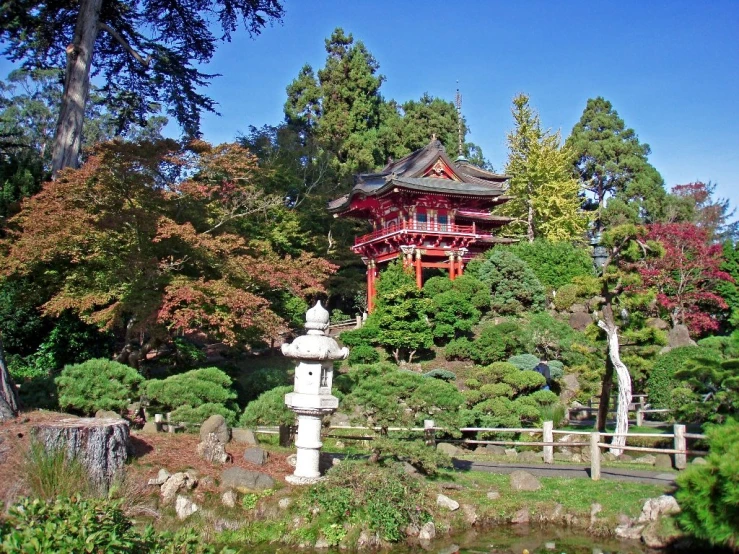 there is a pagoda and garden at the bottom of this hill