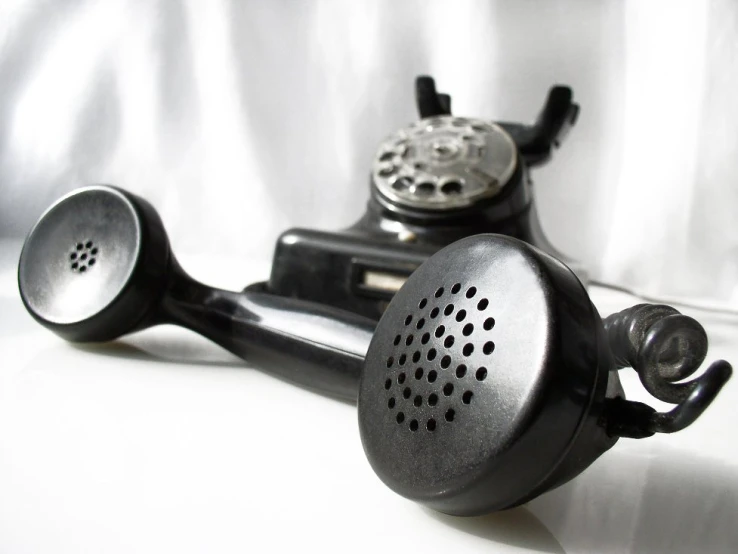 a vintage - style telephone that is sitting on a white surface